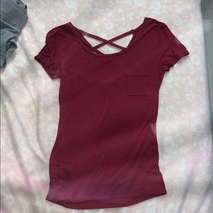 red shirt, crosses on back. perfect condition